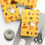 Thumbnail: Wrapped gifts on yellow South Dakota Gift Wrapping Paper with string and scissors.