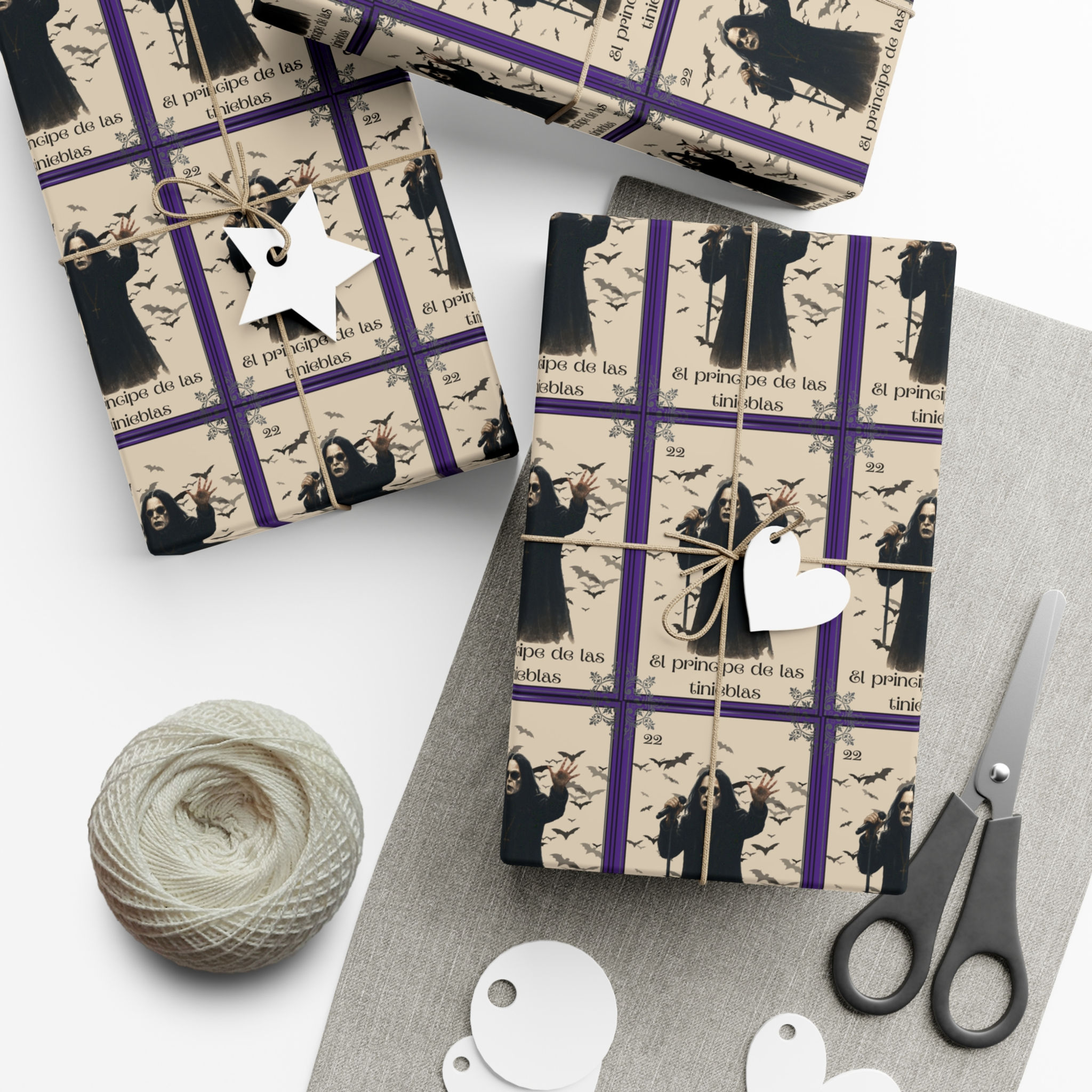 Wrapped gifts with tag and scissors on white surface, Halloween gift wrapping