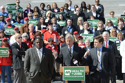 Gov. Beebe, flanked by legislators, making the case for "jobs" via Medicaid expansion.