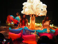 A performer dancing on stage in Symphony of Lights, an empowering dance show about self-love and healing