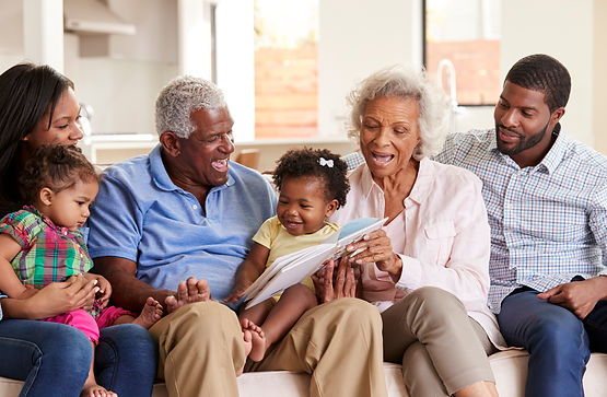 multi-generation-family-sitting-on-sofa-