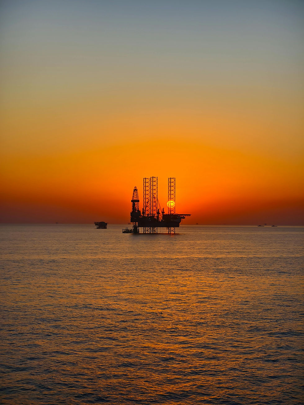 Offshore oil rig at sunset representing oil price risk and Middle East geopolitical tensions