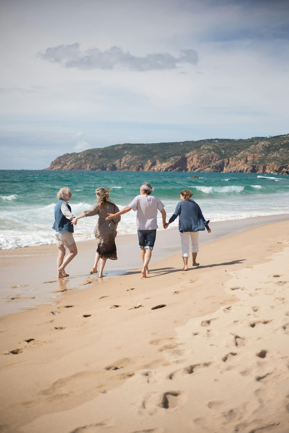 Expat retirees walking along a coastline during retirement while planning for inflation and future living costs