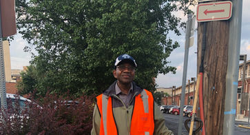 Man posing with a trash bag and supplies during a trash cleanup