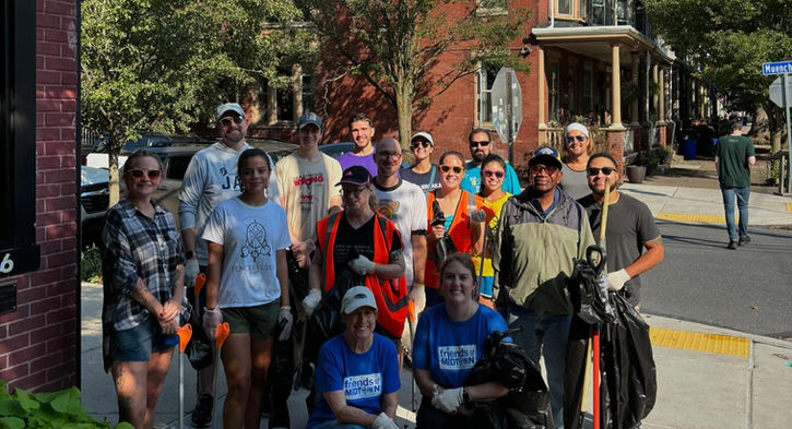 Group posing outside after a trash cleanup