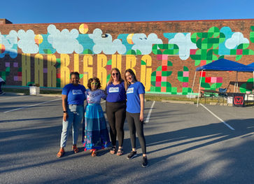 People posing in front of the mural at the Midtown Cinema