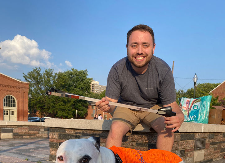 Man with a dog outside after a litter cleanup