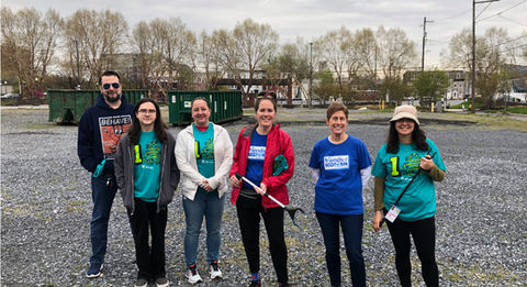 Group posing outside after a trash cleanup