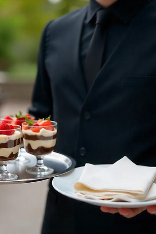 banquet server holding a tray of food