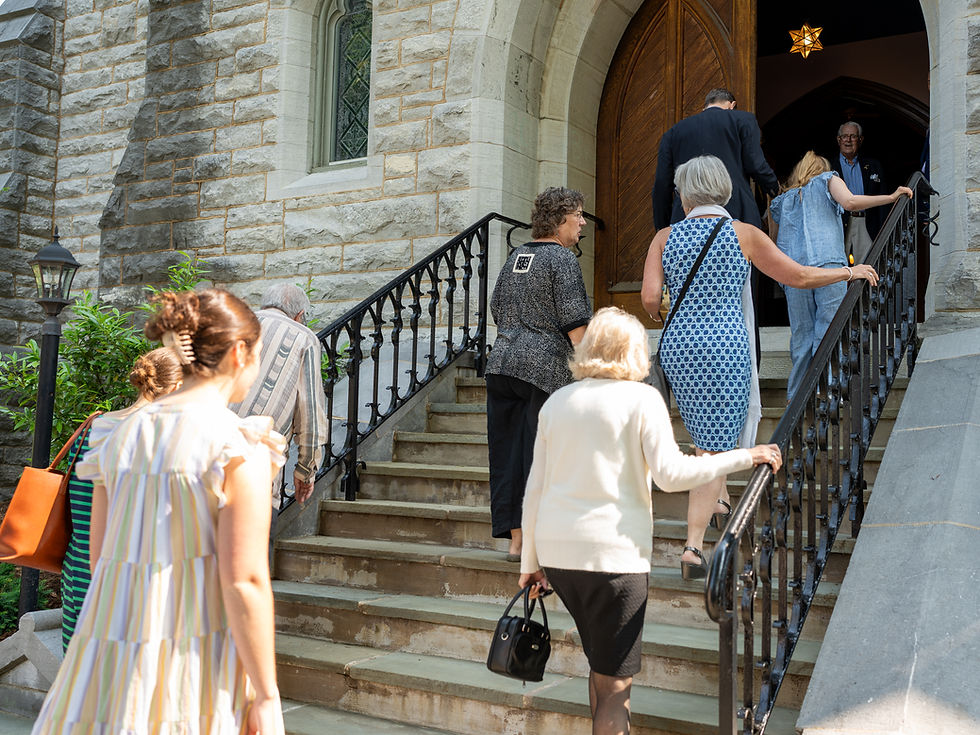 A hand gently traces a labyrinth printed on a sheet of paper