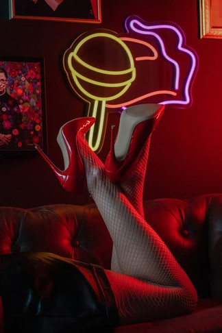 Boudoir legs and heels kicked back with neon