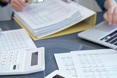 Business colleagues reviewing financial documents and calculating taxes. Auditor inspectin