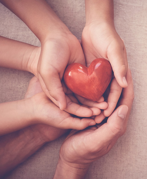 three hands all holding a red heart