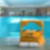 Yellow robotic pool cleaner next to an indoor pool
