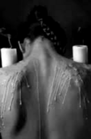 A masochist with candles dripping down her back