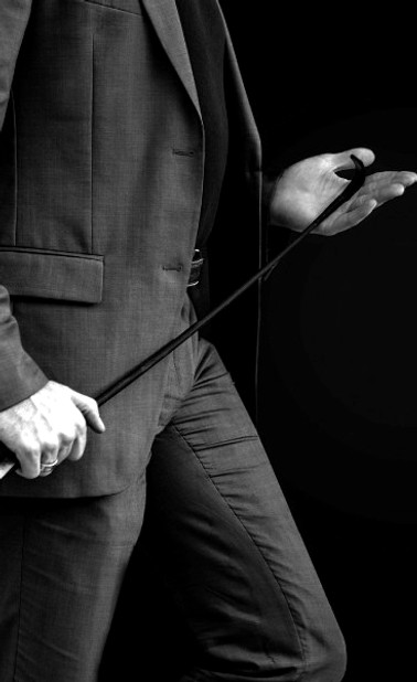 A dominant male holding a crop