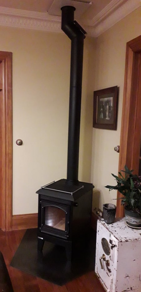 Completed Firenzo Wood burner with offset flue which was swapped out from an old exisiting fireplace in a house in Wanaka