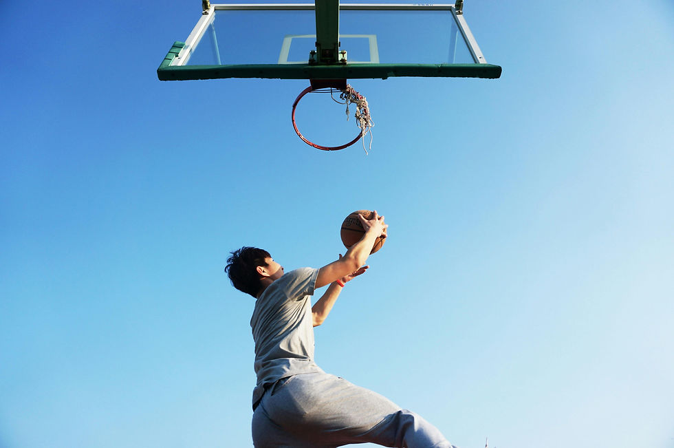 A middle-aged man taking a shot in basketball as a symbol to achieve a goal.