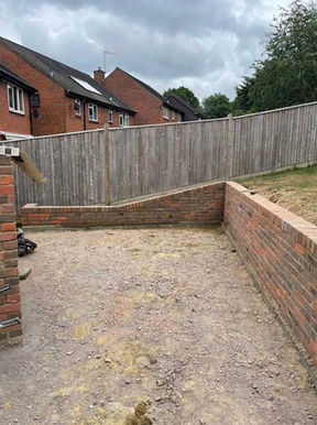 Patio and pavement in the foreground in a outdoor garden setting.