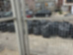 Volunteers fill black plastic bags with the trash they find in the lot.