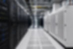 Modern data center infrastructure with server racks, perforated floor panels, and cooling equipment