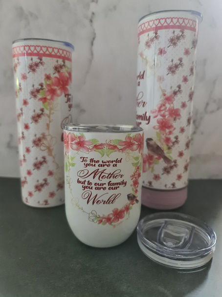 Image: a set of sublimated tumblers using the same image on different sizes.