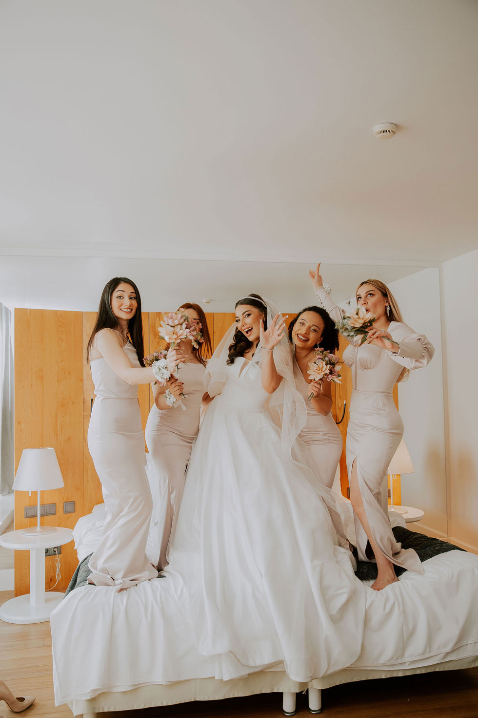 Group of bridesmaids in matching robes preparing for the wedding day.
