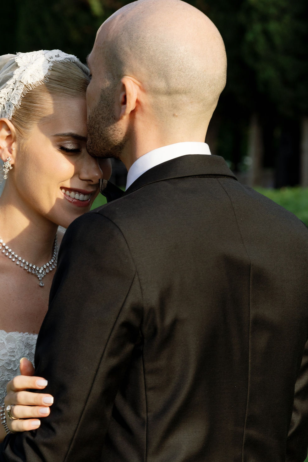 Bride and groom embracing during wedding ceremony.