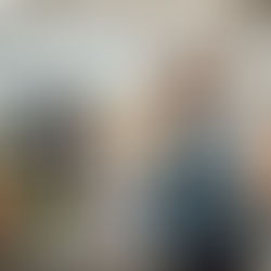 woman in a library using a computer with headphones