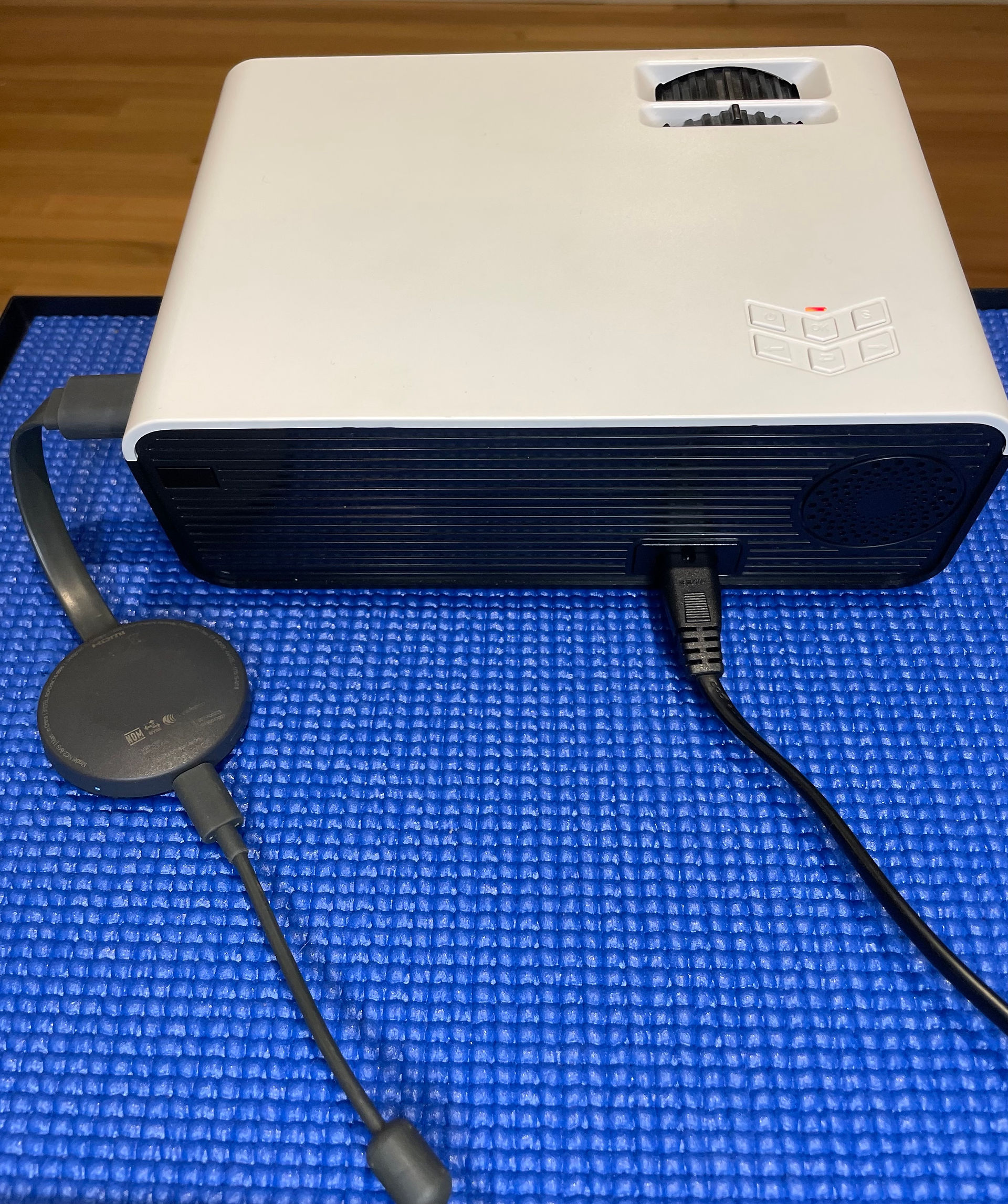 Projector unit with chromecast device and power lead plugged into it