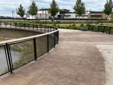 Curved pedestrian walkway at Westlake Park – The Farm with custom steel and mesh railing fabricated and installed by FabHar.