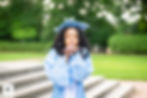 Graduate in blue cap and gown blowing a kiss outdoors — Novitsky Photography
