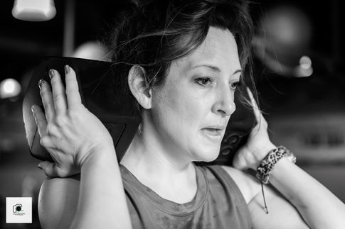 Dancer with hand raised focusing in black-and-white.