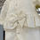 Thumbnail: Mintini cream frill babygrow with a gold glitter bow, gold and white pearls, glittery tulle frills & a large bow on the back