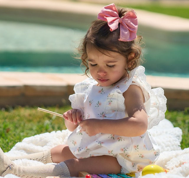 Rapife white romper with a peach floral print detailed by broderie frill on the shoulders