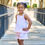 Thumbnail: Rapife Blush pink gingham girls short set with frill trim on the bottom of the top and shorts as well as knot tied straps