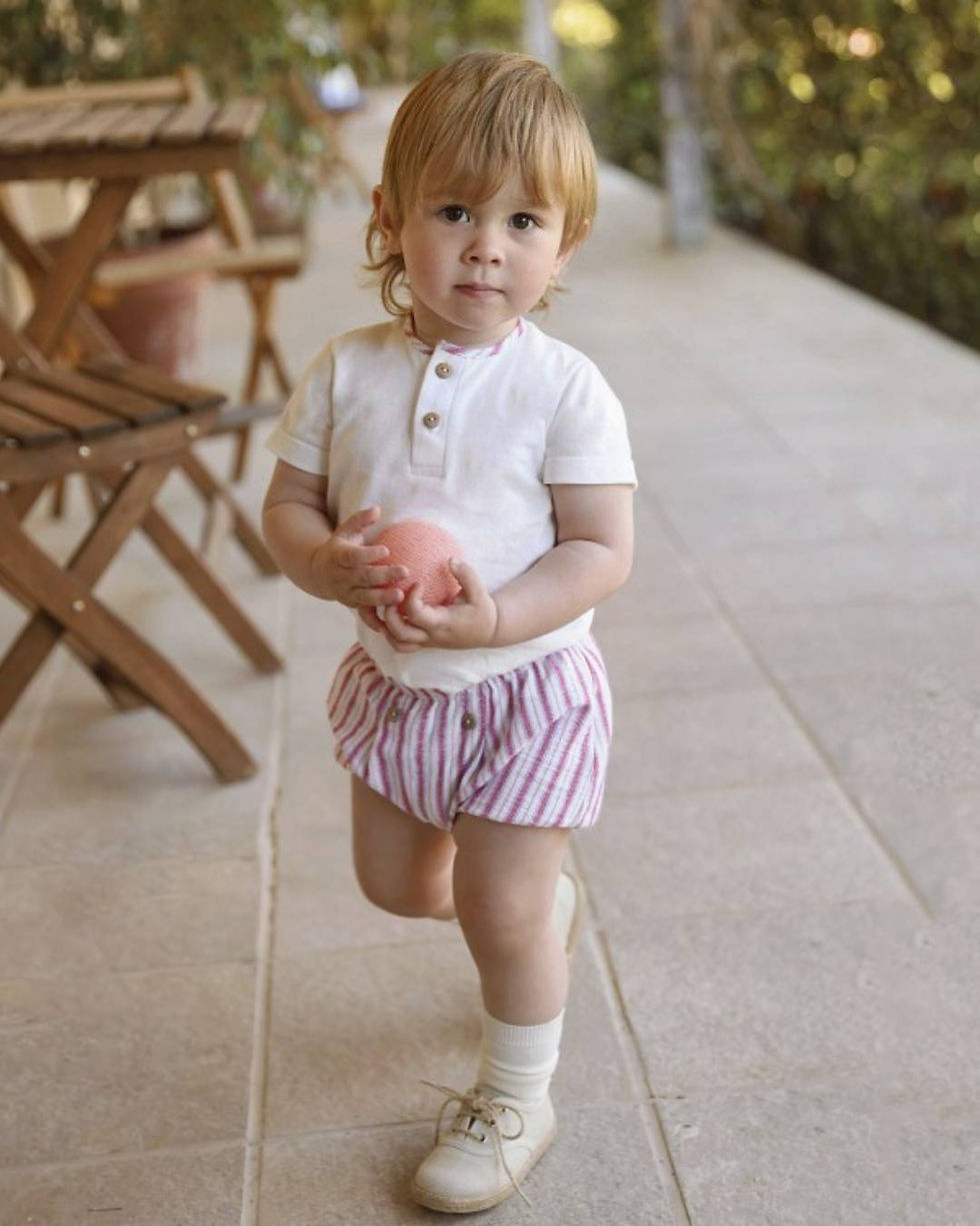 Rapife Elio stripe shorts in red, camel, blue and off white. paired with a white tee with a stripe neck trim