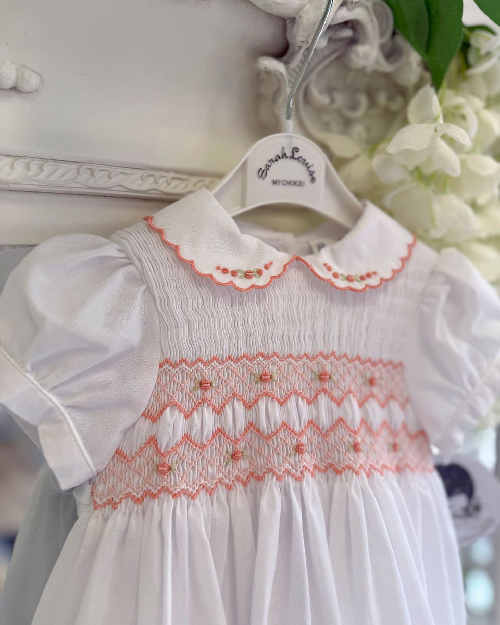 Thumbnail: Sarah louise white dress with full smocked chest and peach embroidery