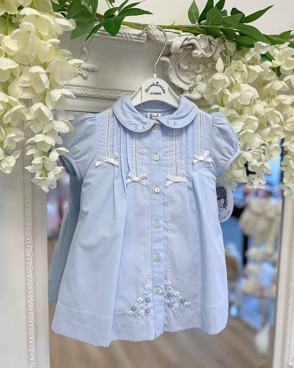 Sarah Louise A line baby blue dress with feather stitch trim, chest pleats, dainty white bows and embroidered flowers