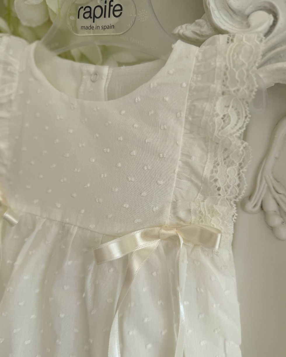 Thumbnail: Rapife ivory romper with a dot print, frill lace sleeves, and front ivory ribbon bows