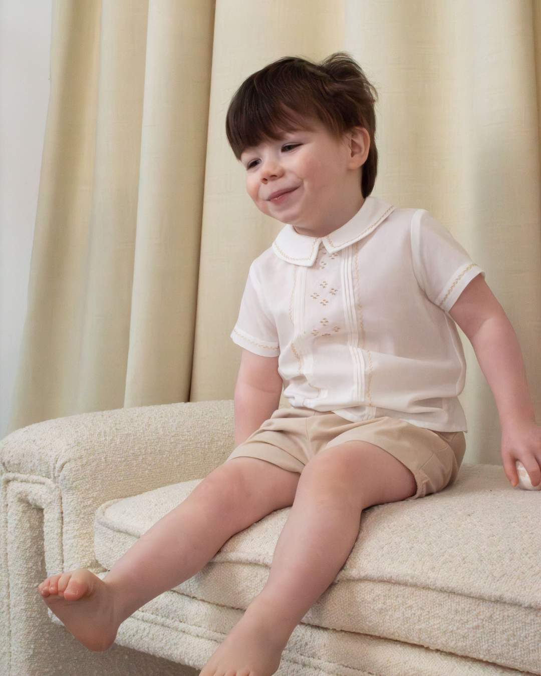 Sarah Louise x Little Lambs Heritage Boys Short Set in a ivory shirt & beige short detailed by a beige feather stitch detail