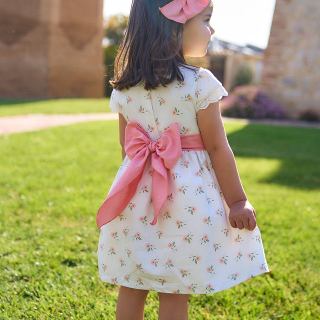 Rapife linen blend white dress with a peach floral print, detailed by a peach waist band which ties into a back bow