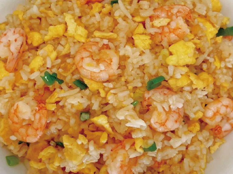 Delicious shrimp fried rice with egg and sliced green onions, a meal.