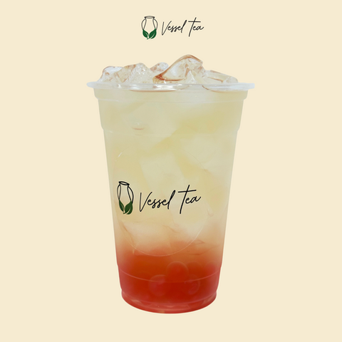 Iced beverage with Vessel Tea logo and visible text, on light beige backdrop.