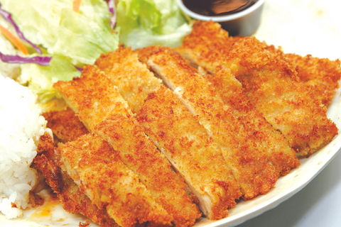 Sliced fried chicken with dipping sauce, salad, and Teriyaki Plus restaurant meal