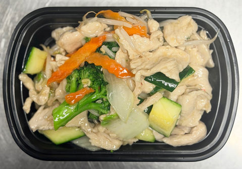 Chicken stir fry with vegetables in a black container, ready to eat.