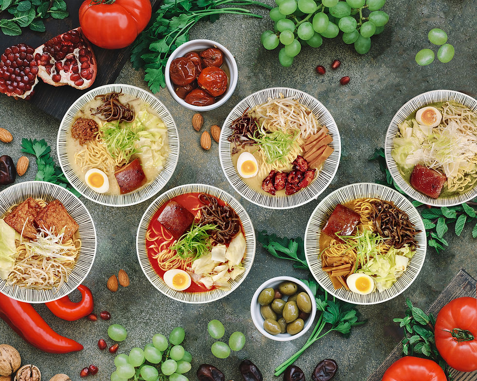 Overhead view of six colorful ramen bowls with fresh fruits and vegetables.