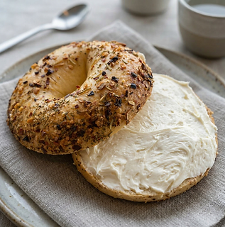Open everything bagel with cream cheese
