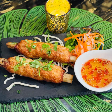 Two delicious shrimp rolls on a plate with sauce, vegetables, Just Pho You