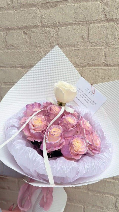 Wrapped bouquet of pink and white roses